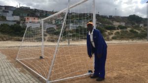 General worker Cekiso poses next to the post he installed